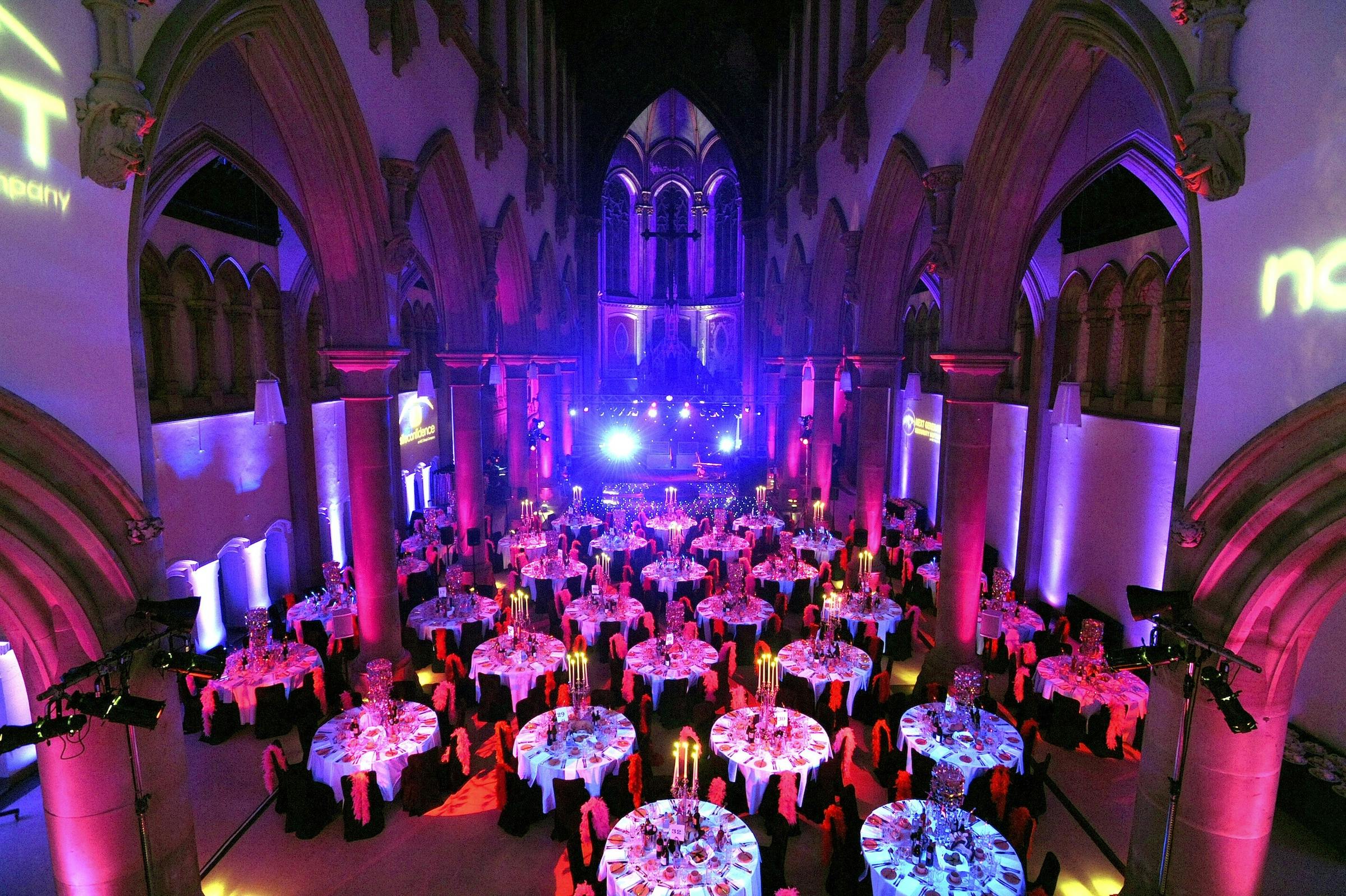 Great Nave, Monastery Manchester: elegant event space with round tables for formal gatherings.