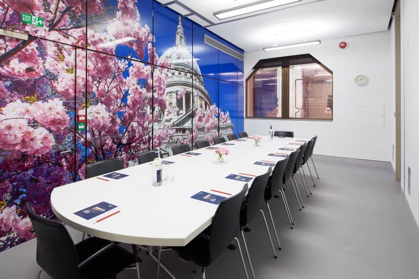 Modern Wren Boardroom with white table, black chairs, cherry blossoms for meetings.