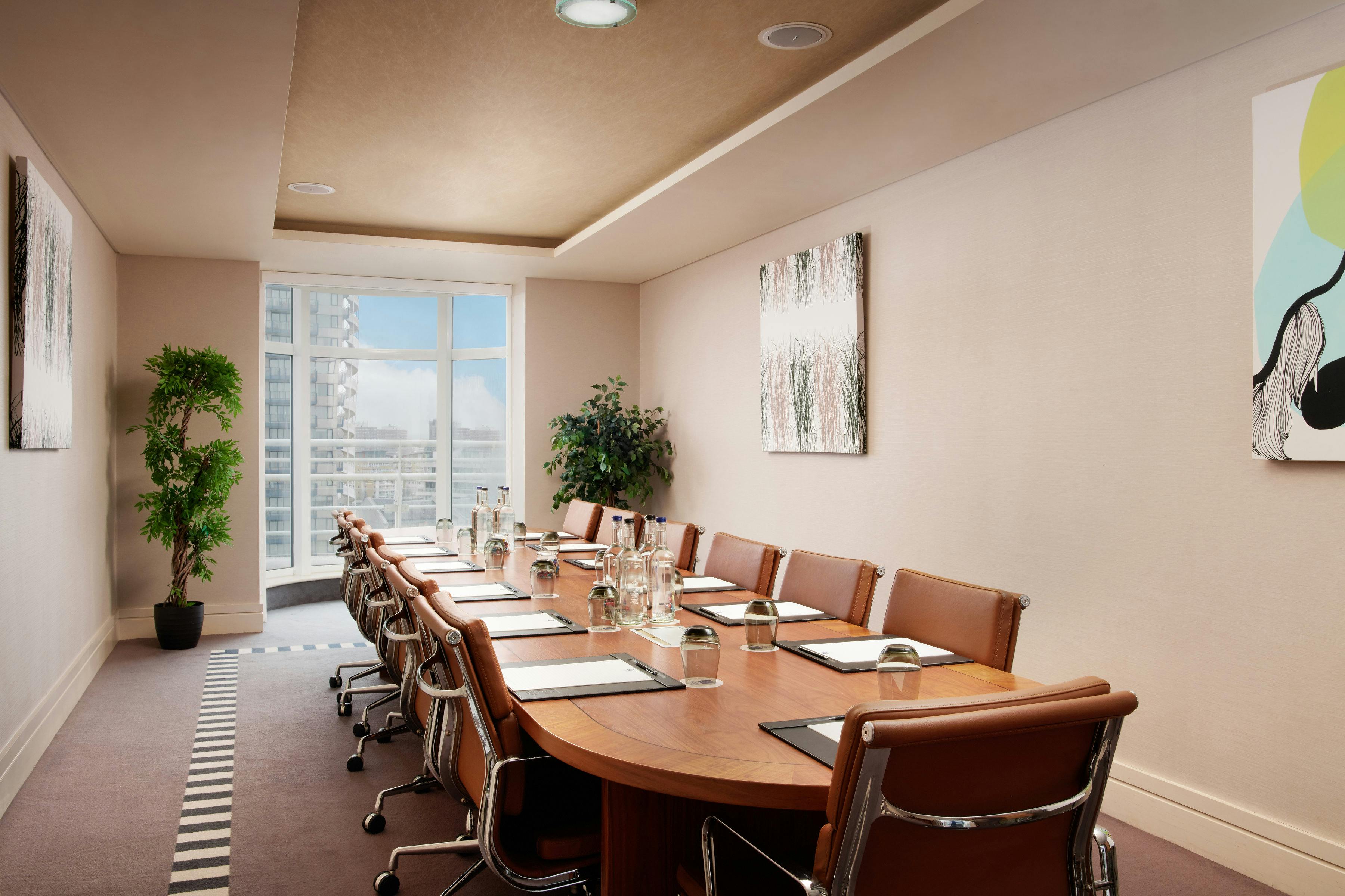 Executive Boardroom at Chelsea Harbour Hotel with oval table, ideal for corporate meetings.