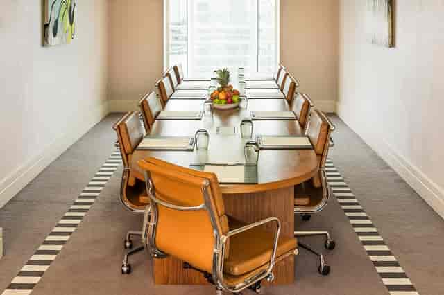 Executive Boardroom at Chelsea Harbour Hotel with polished table, ideal for meetings and events.