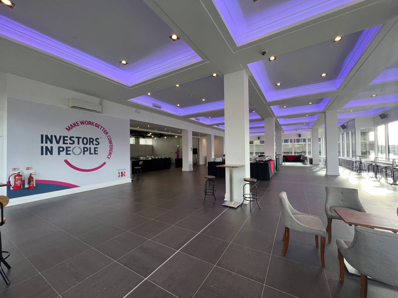 Upper River Room, modern event venue with natural light for corporate networking and presentations. - Banner