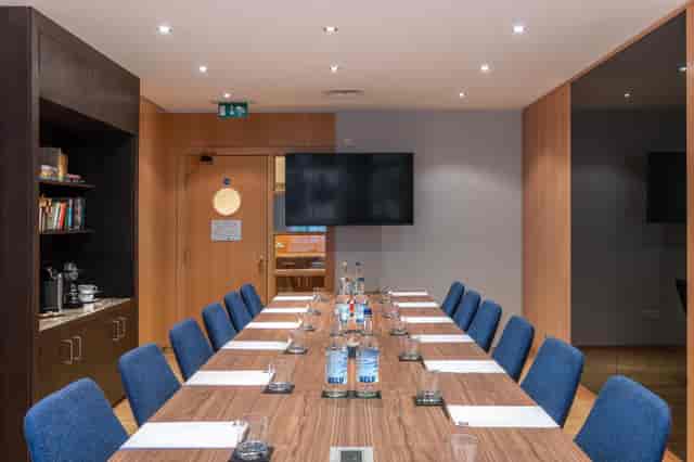 Modern meeting room in K+K Hotel George, ideal for corporate events and presentations.