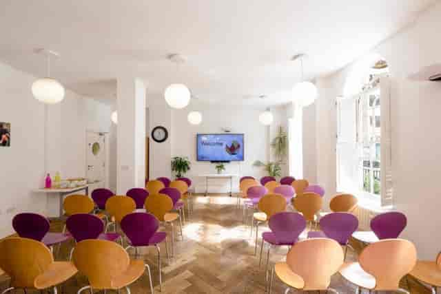 Modern meeting space in Fitzrovia with colorful chairs for workshops and presentations.