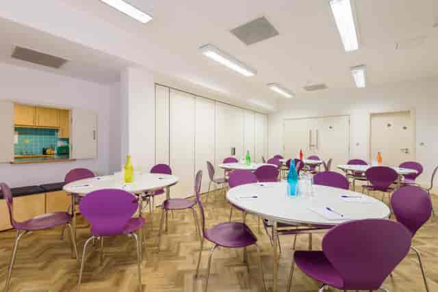 Crisp Room at Fitzrovia Community Centre featuring purple chairs for workshops and events.