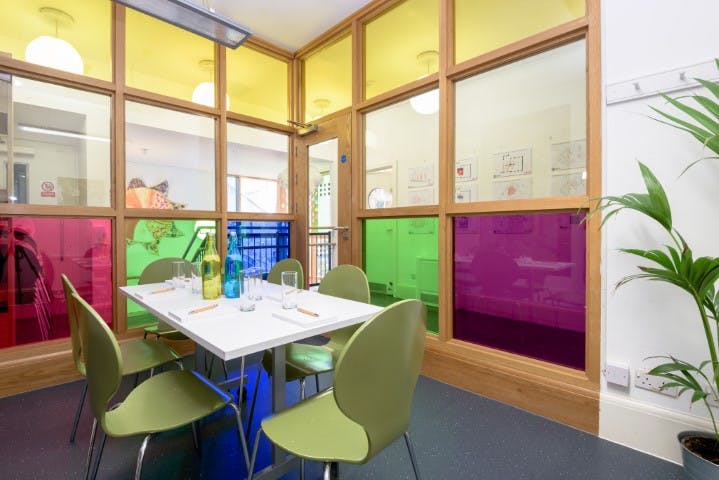 Vibrant meeting room with colorful glass panels for creative brainstorming sessions.