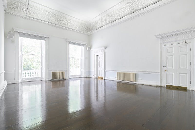 Spacious ICA event space with large windows, ideal for corporate and social gatherings.
