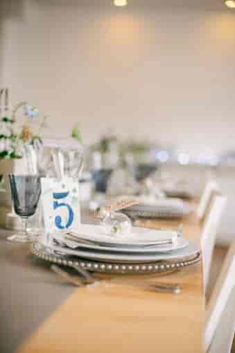 Elegant dining table setup with floral arrangements for weddings and upscale events.