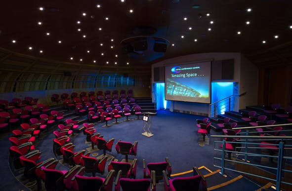 Modern circular auditorium with tiered seating for conferences and workshops.