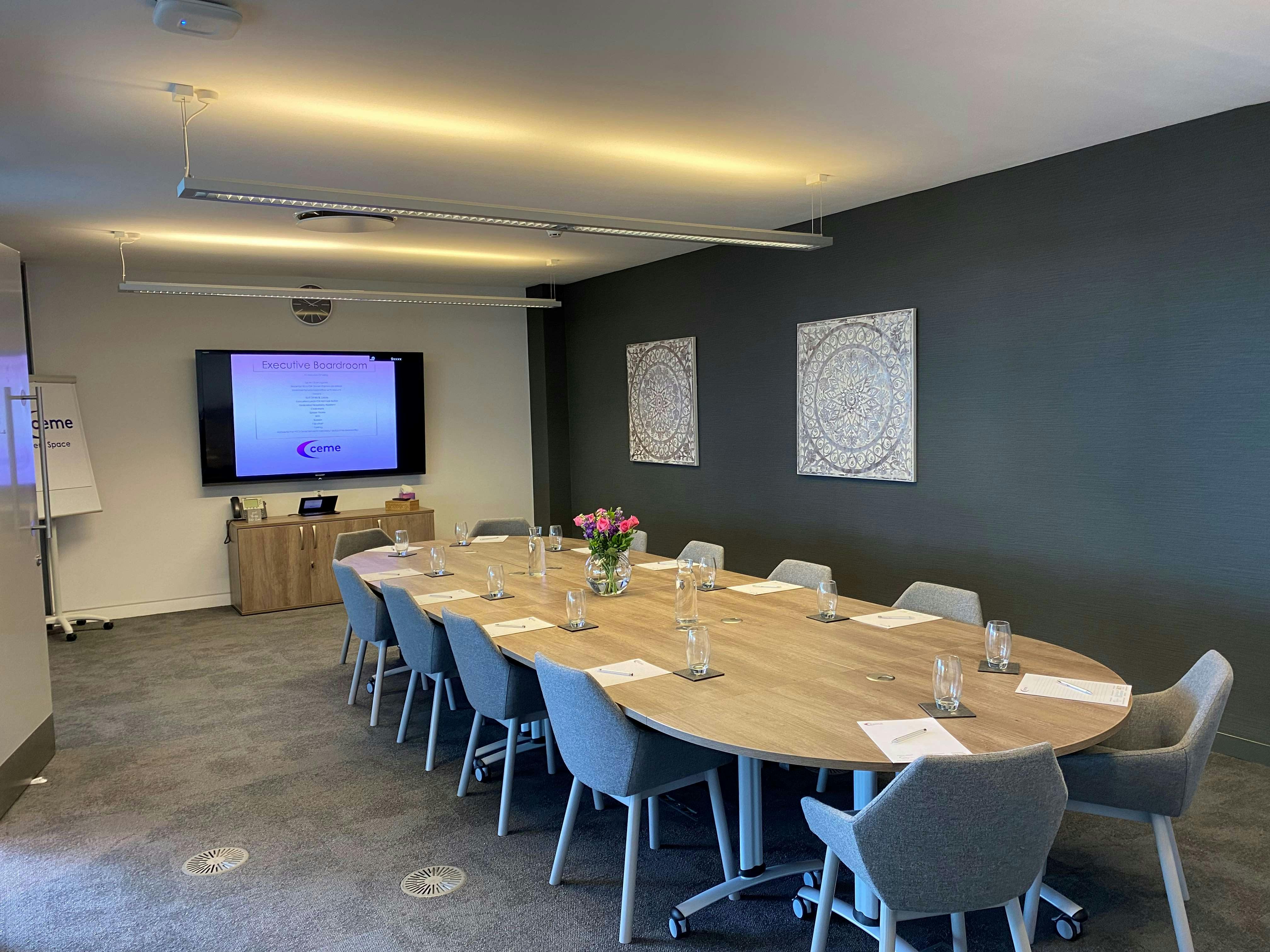 The Boardroom at CEME Events Space, featuring a long oval table for meetings.