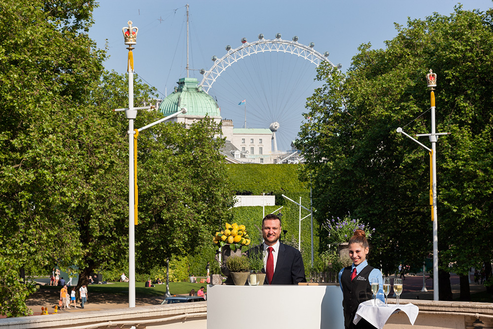 Outdoor event at The Royal Society with London Eye backdrop and elegant service staff. - Banner