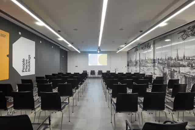 Modern conference room with black chairs, ideal for workshops and seminars.