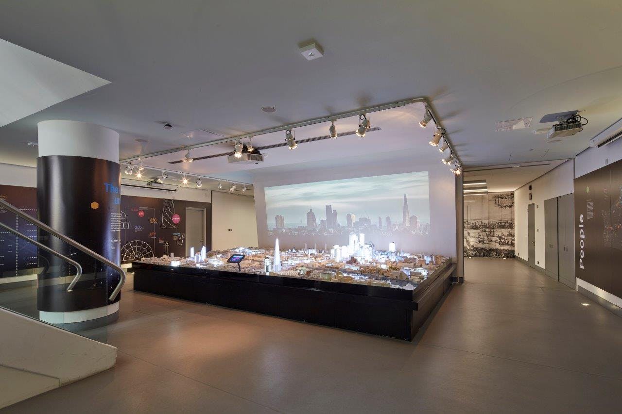 Modern event space with city skyline model, ideal for corporate meetings and showcases.