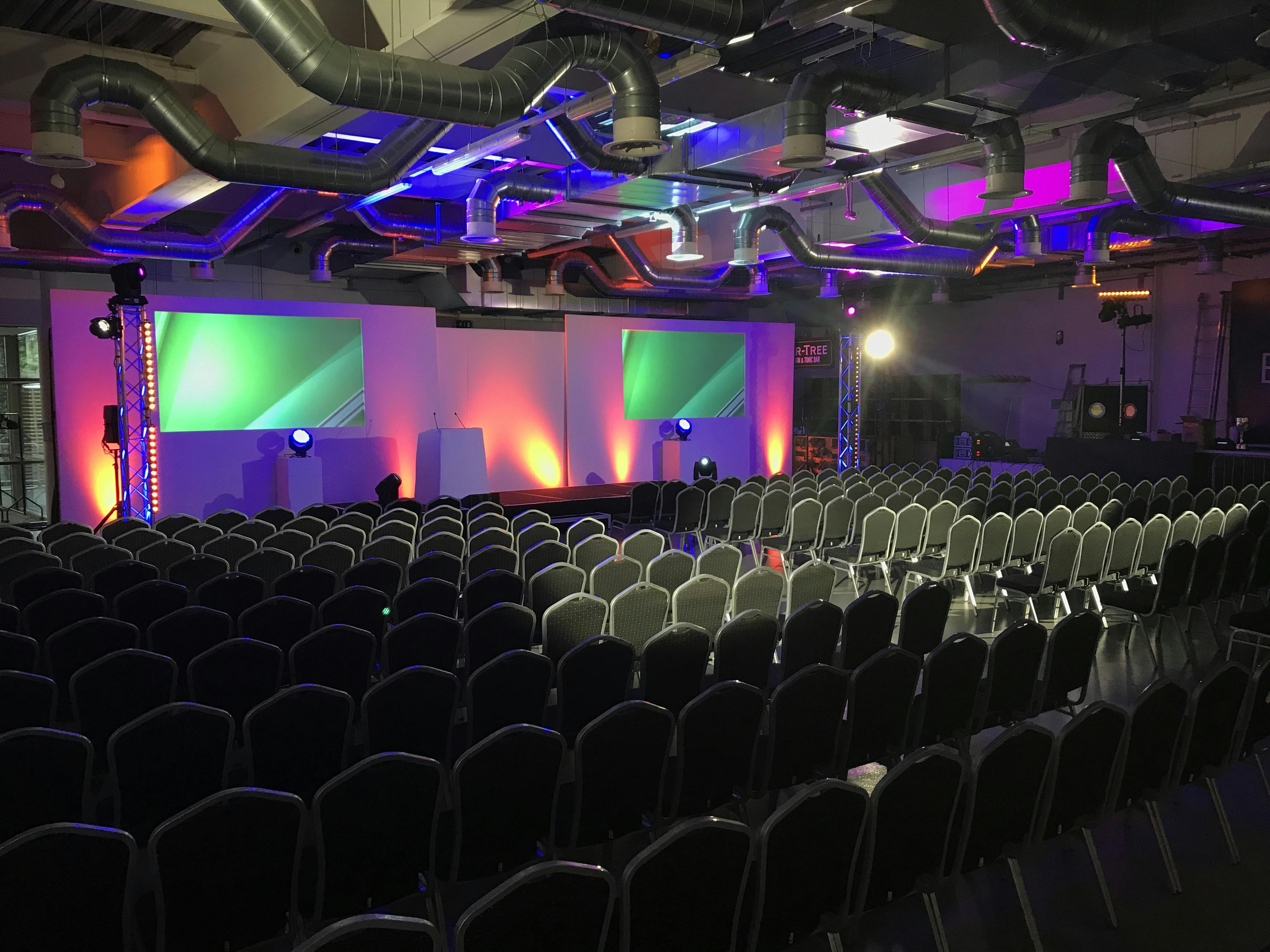 Jardine Suite at Kia Oval: vibrant event space with stage, ideal for conferences and presentations.