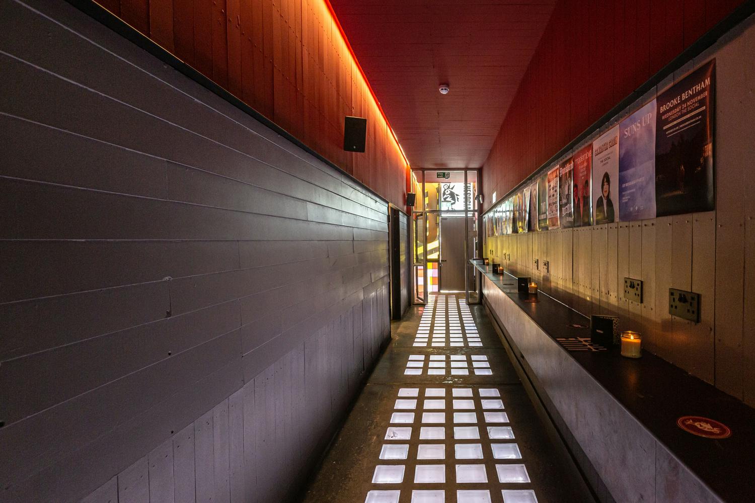 Modern event corridor at Upstairs Bar with ambient lighting for corporate meetings.