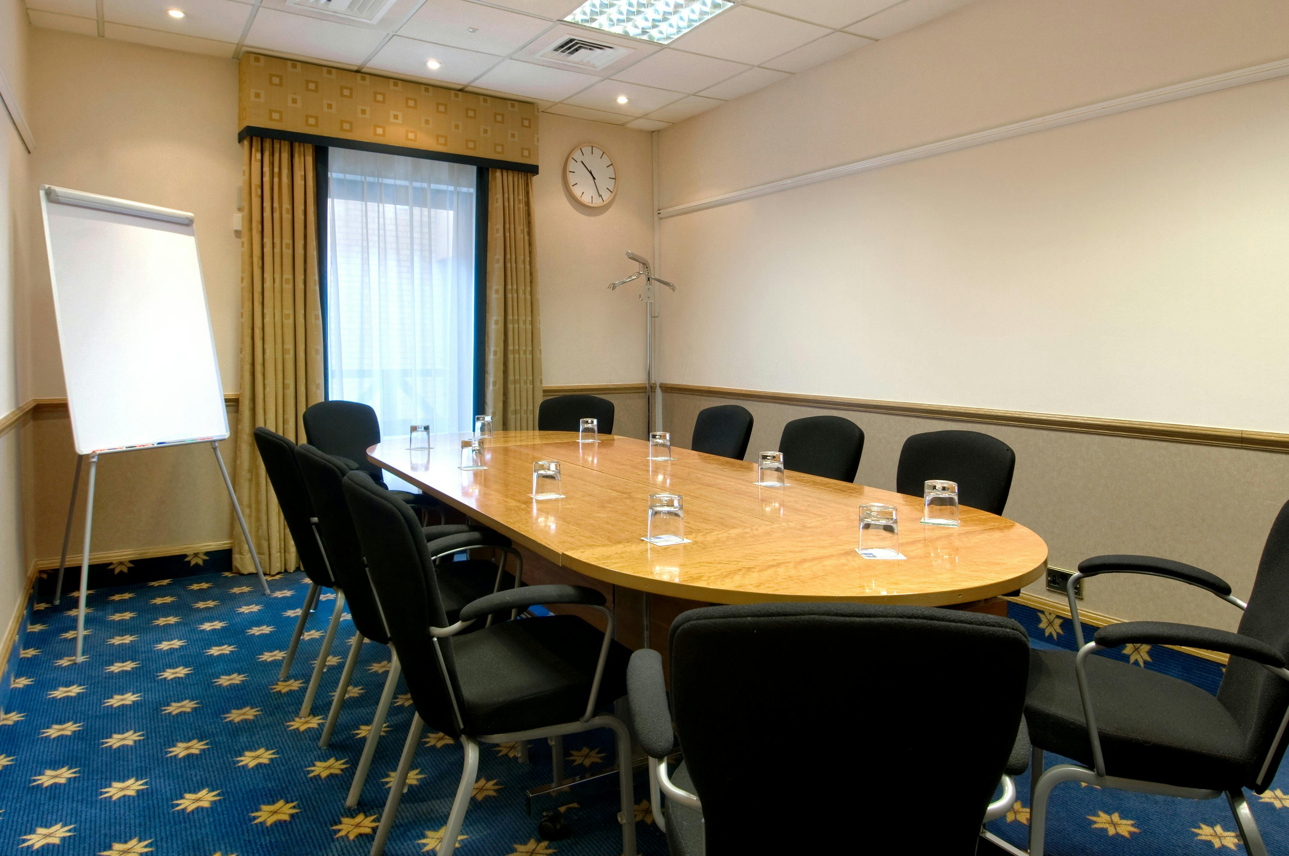 Kaitak Room at Hilton Manchester Airport, oval table, ideal for professional meetings.