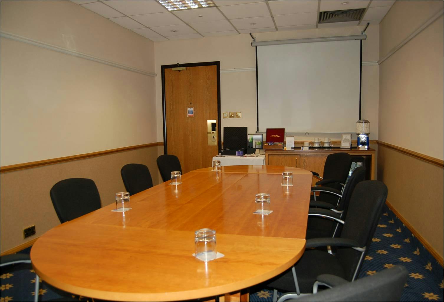 Orly Room at Hilton Manchester Airport, featuring a large conference table for meetings.