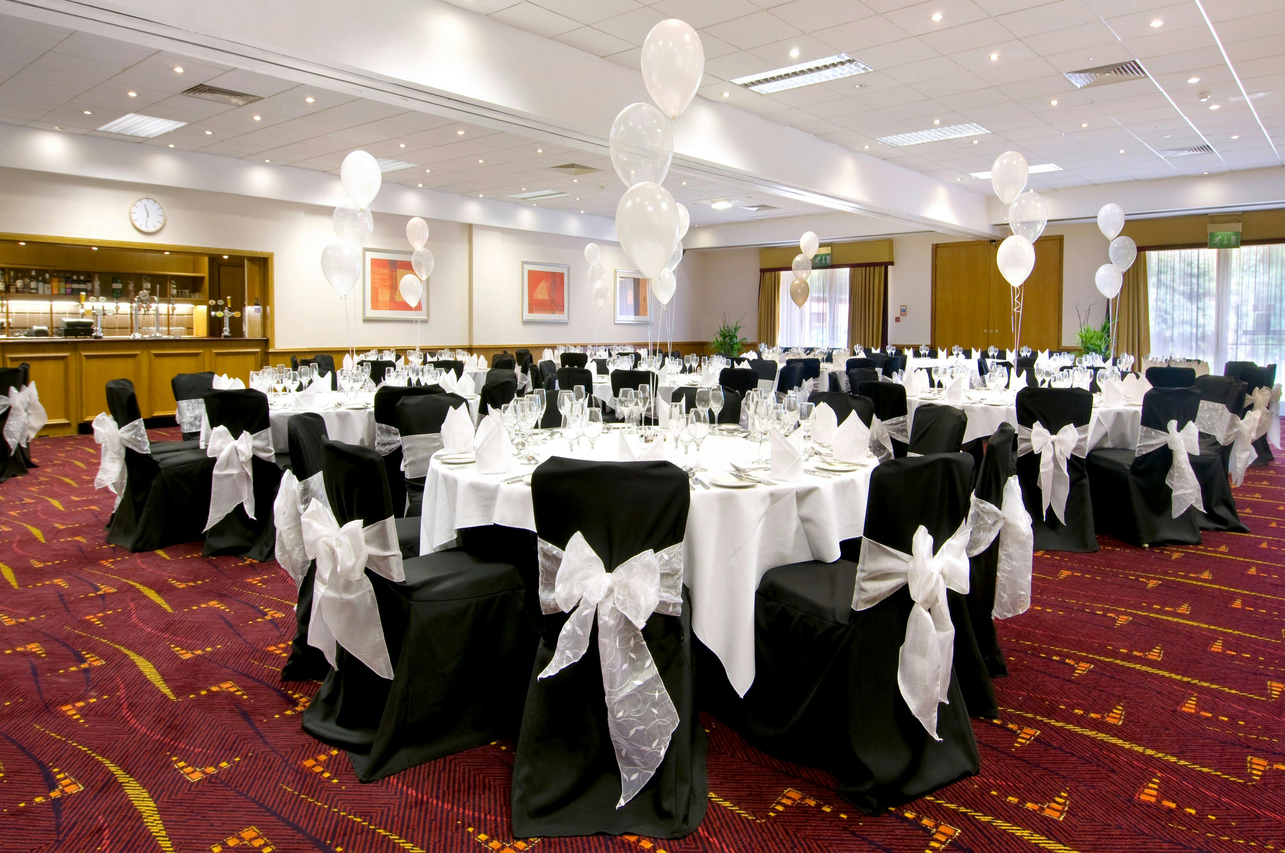 Schiphol Suite banquet setup at Hilton Manchester Airport with elegant tables and balloons.