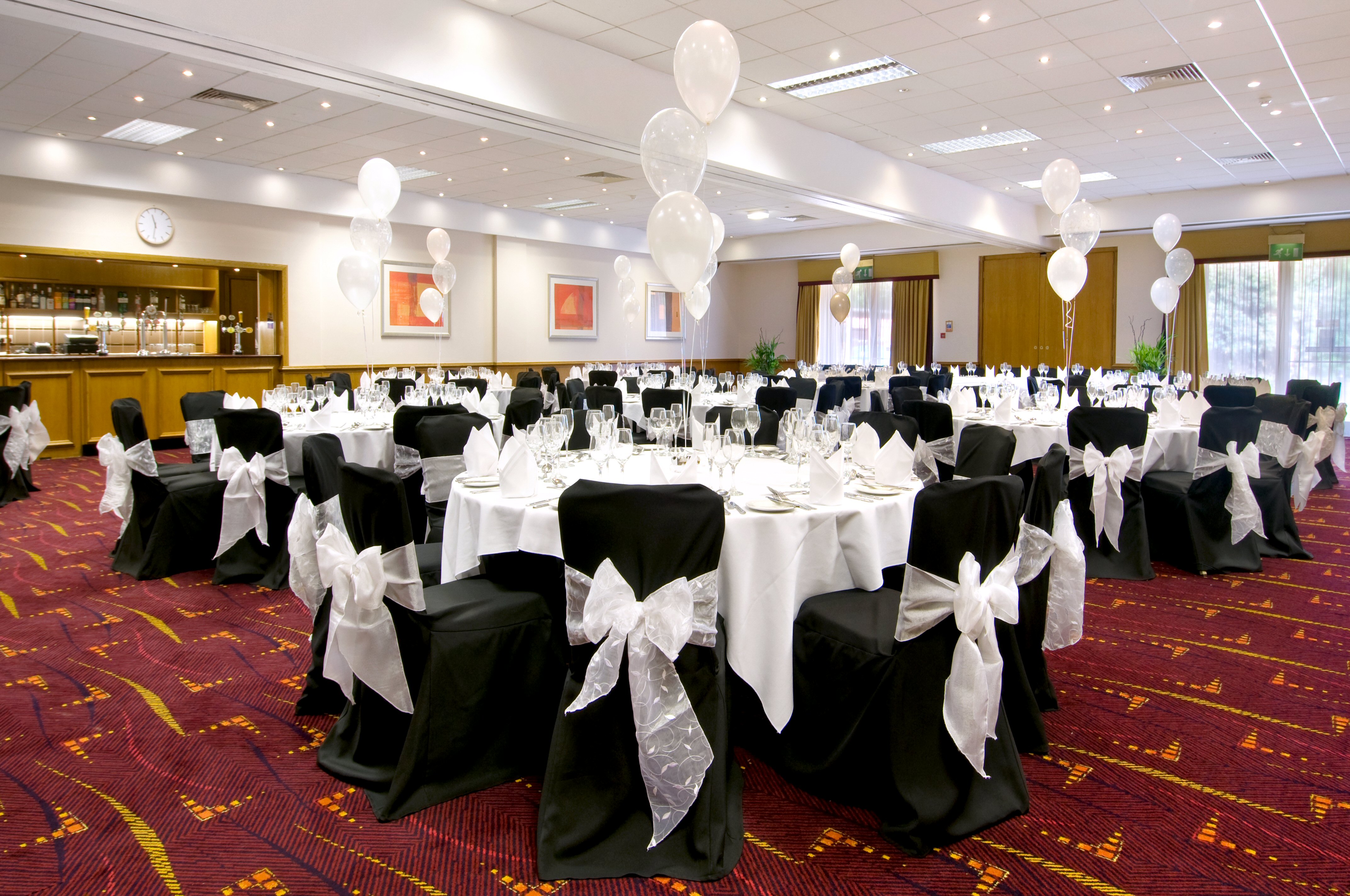Schiphol Suite banquet setup at Hilton Manchester Airport with elegant tables and balloons. - Banner