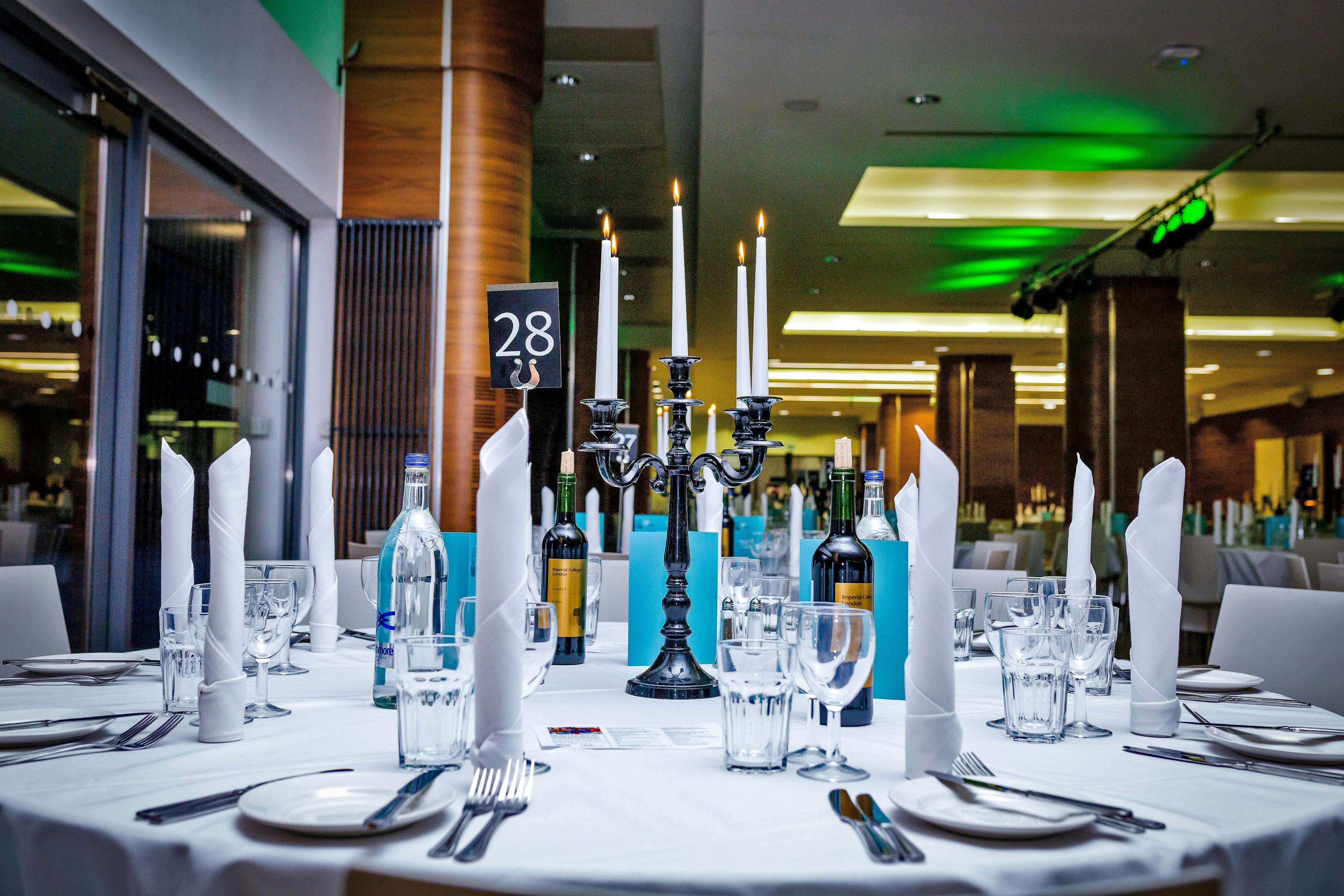 Elegant dining table with candelabra at Queen's Tower Rooms, ideal for formal events.