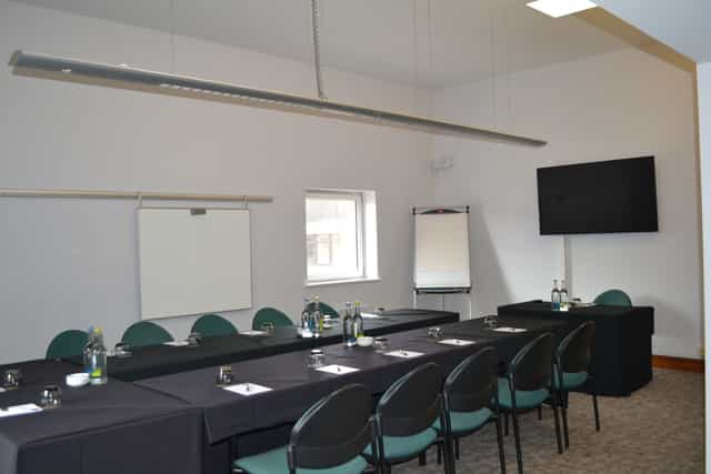 Adamson Suite meeting room with long table, ideal for conferences and presentations.