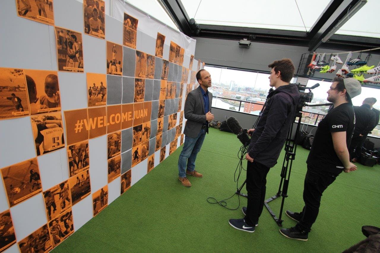 Heaven at Hotel Football: vibrant event setup with green turf and branded backdrop.