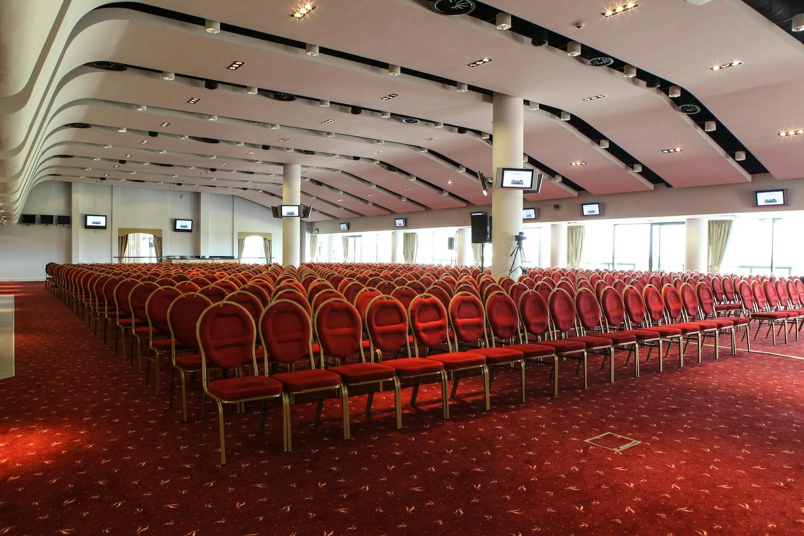 Sunloch Suite at Aintree Racecourse, spacious venue with red chairs for conferences.