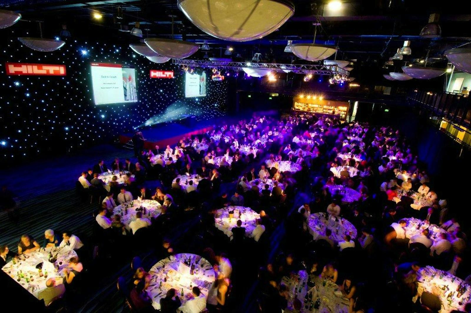 Premier Suite at Bolton Whites Hotel, elegant tables for corporate event with ambient lighting.
