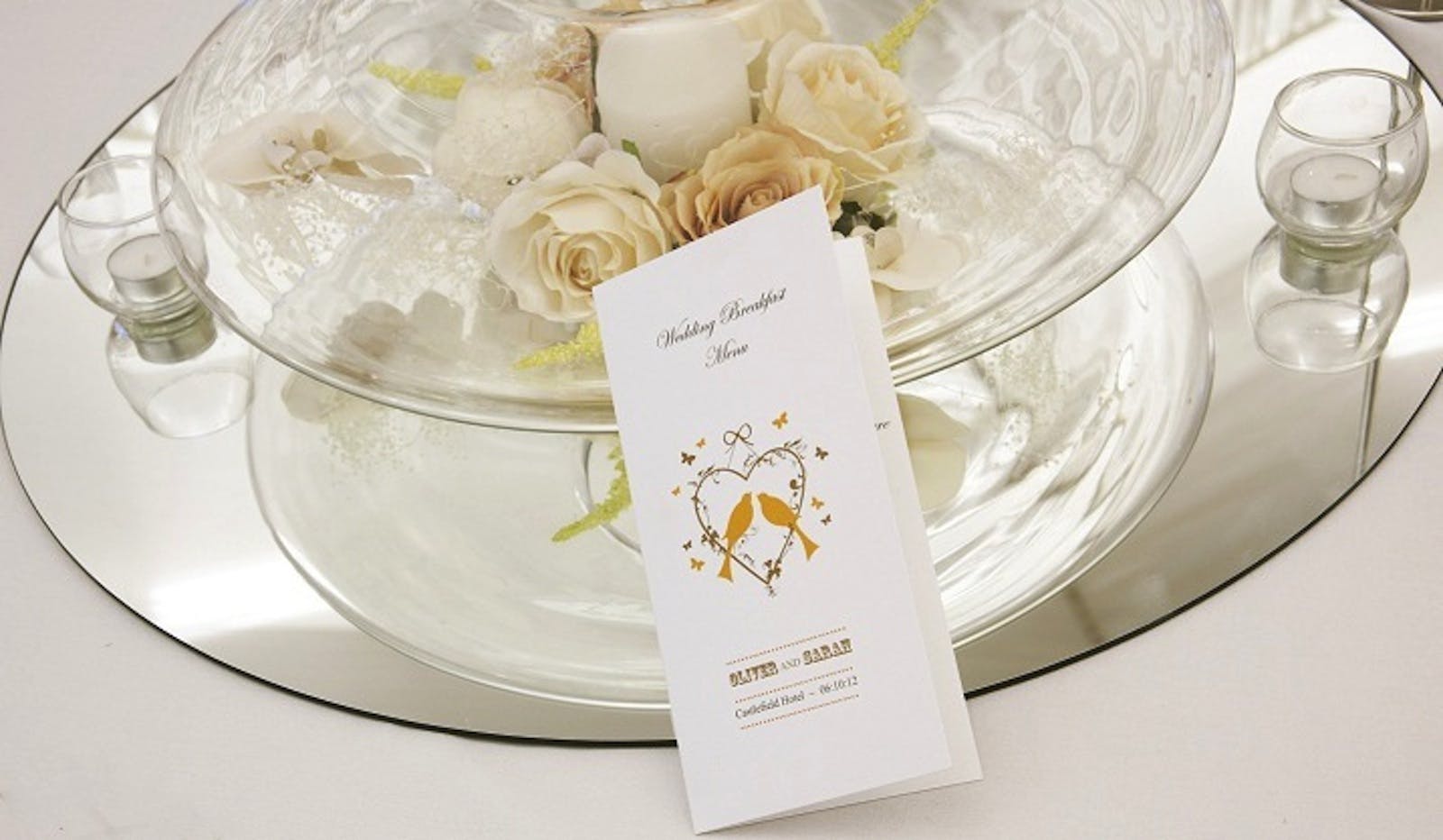 Elegant table setting with roses and candle at Castlefield Hotel for weddings.