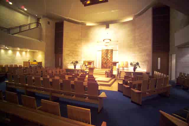 The Sanctuary at The Liberal Jewish Synagogue with theater-style pews for events and conferences.
