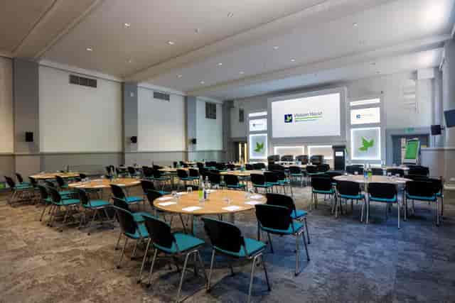 Woburn Hall ballroom with round tables for hybrid conferences and professional business events.