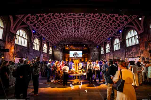Networking reception in Battersea Arts Centre Grand Hall, featuring iconic barrel-vaulted ceiling.