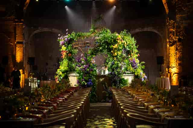Botanical backdrop in Battersea Arts Centre Grand Hall for immersive wedding and corporate events.