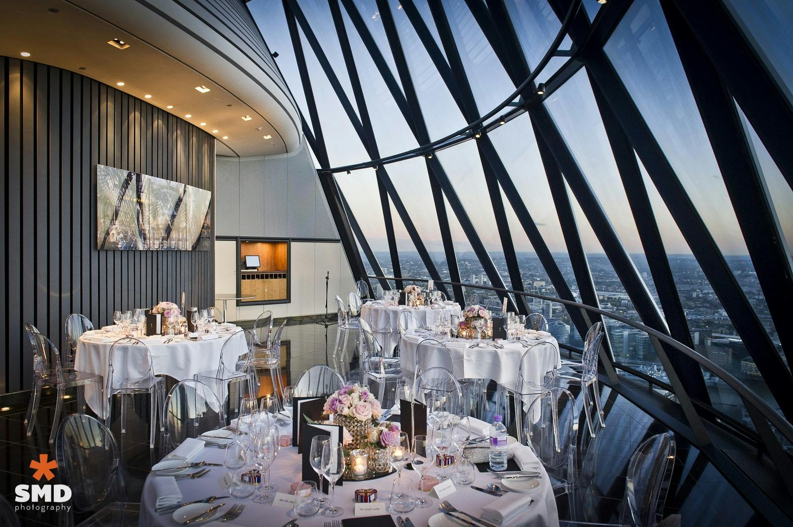 Elegant event space with round tables and panoramic views at Searcys, Gherkin.