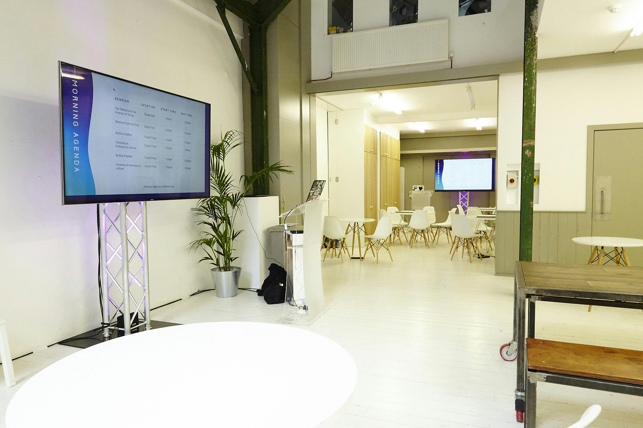 Modern event space in White Rabbit Shoreditch with sleek presentation screen and versatile seating.