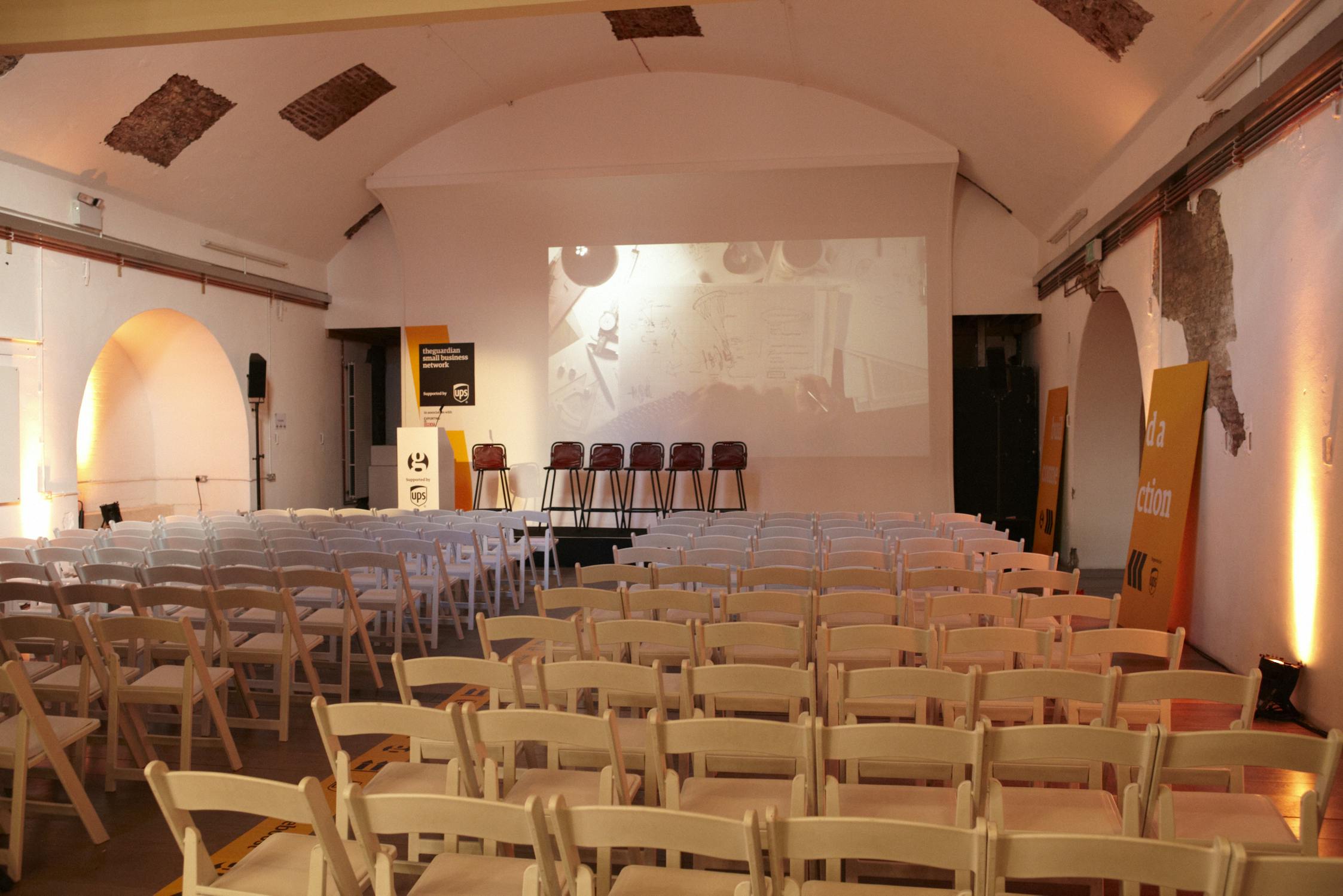 Event space in White Rabbit Shoreditch with white chairs, ideal for conferences and workshops.