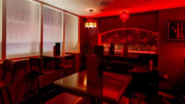 Cozy Apothecary Bar with warm lighting, perfect for private events and gatherings.
