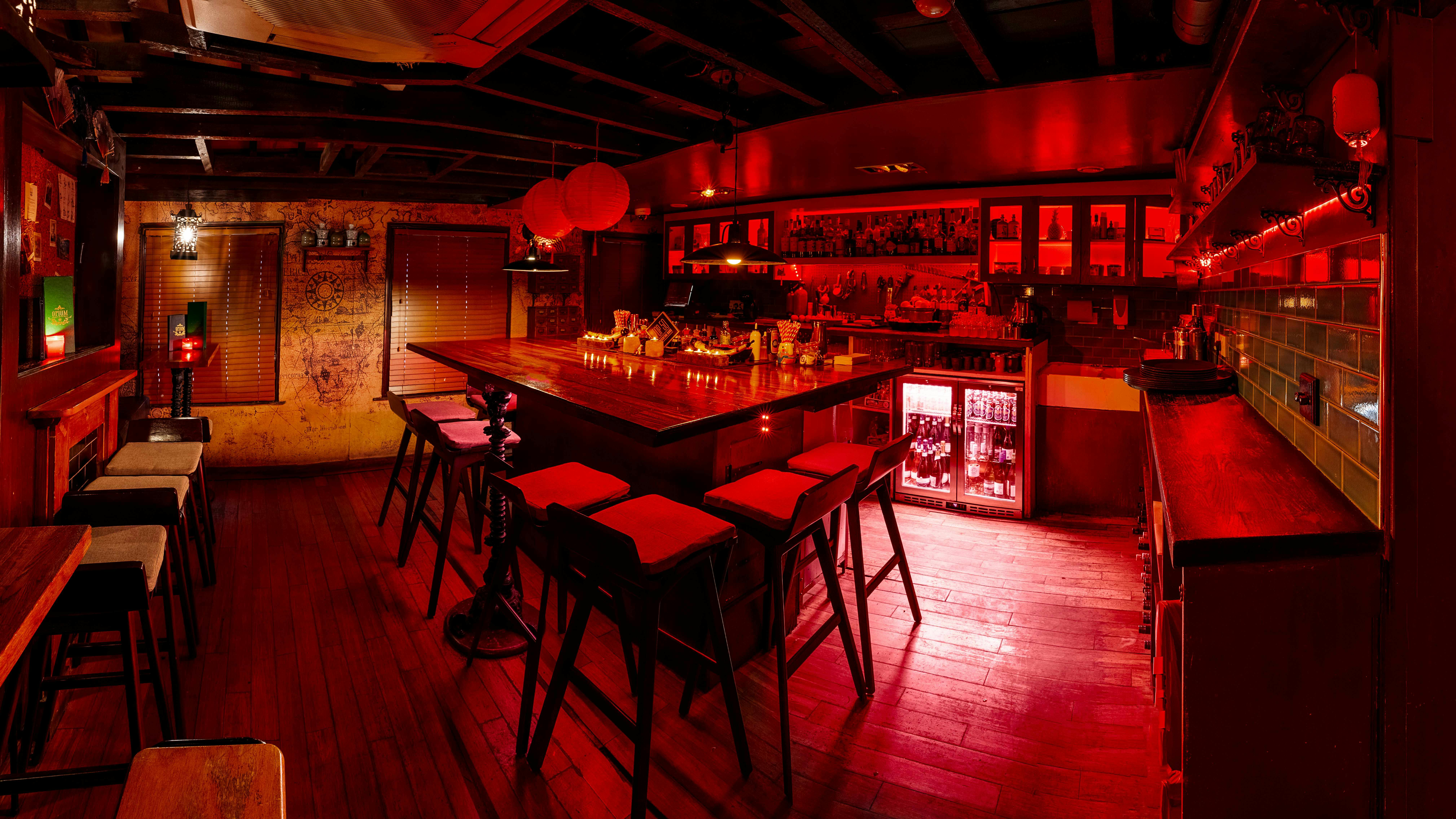 Stylish bar at Opium Cocktail & Dim Sum, perfect for intimate networking events.