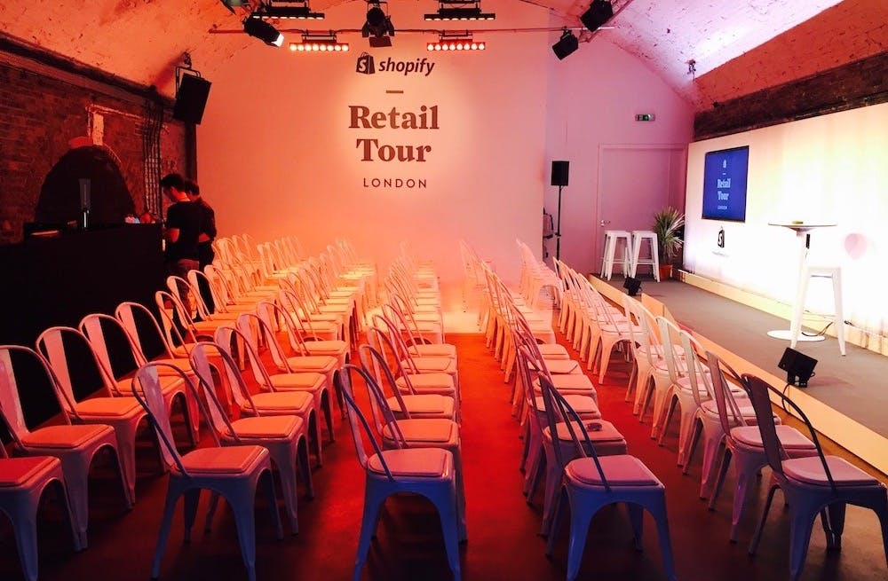 Event space in Shoreditch for Shopify Retail Tour, featuring organized white chairs.