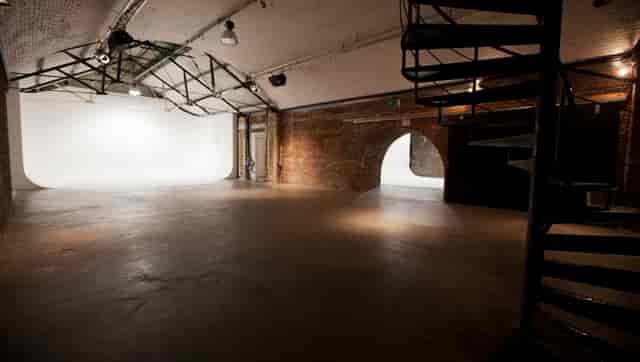 Versatile Shoreditch event space with exposed brick and spiral staircase for meetings and workshops.