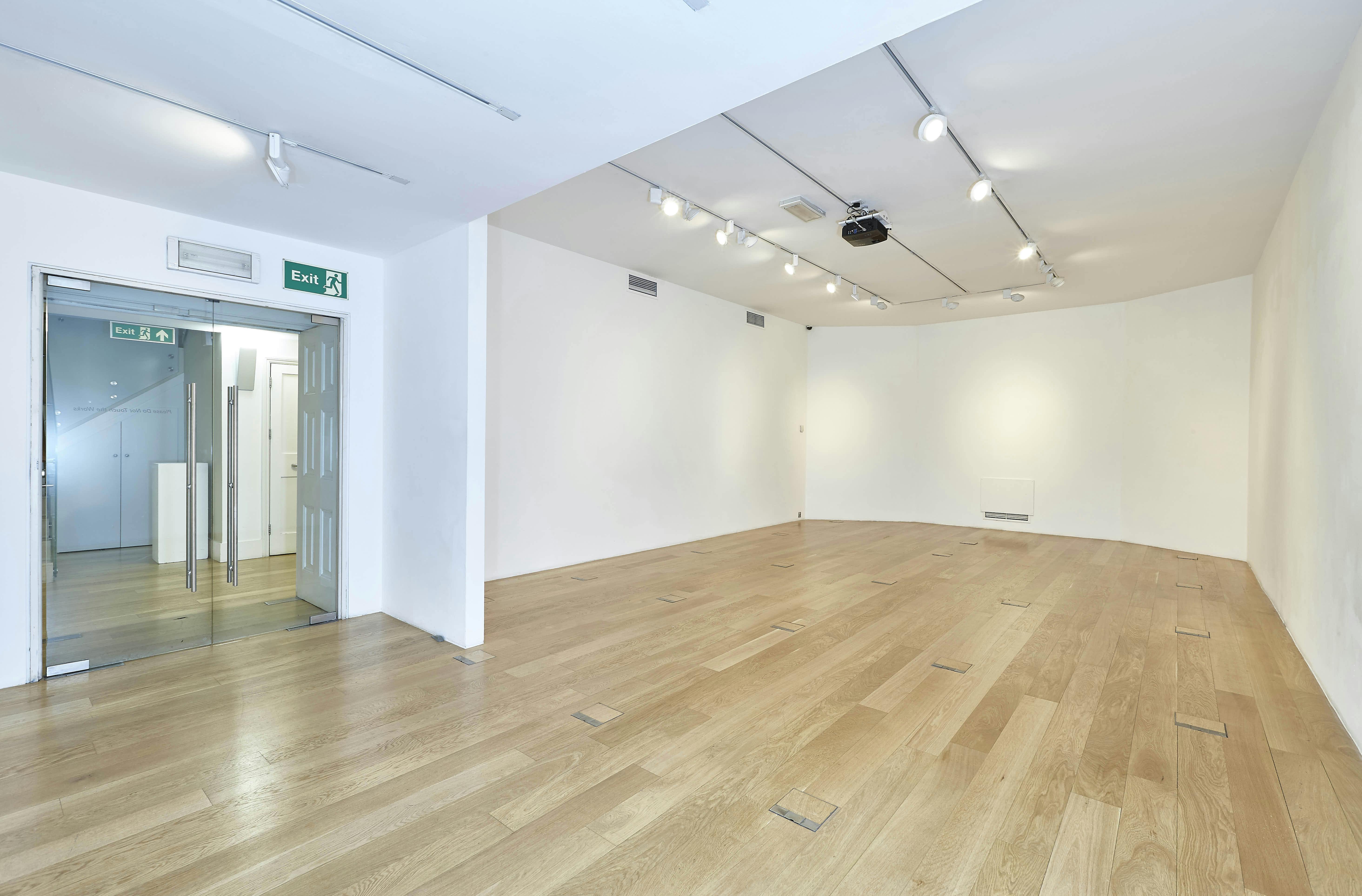 Versatile event space in Asia House with natural light, ideal for meetings and exhibitions.