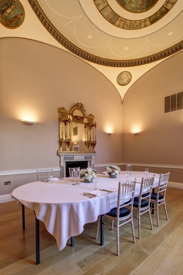 Elegant meeting room with round table, perfect for intimate gatherings and events.