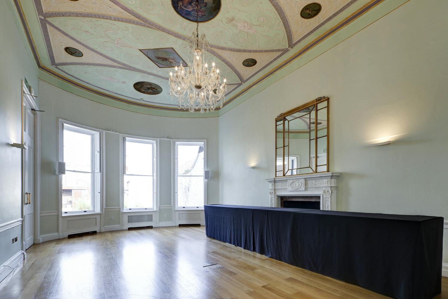 Elegant meeting room with chandelier, ideal for corporate events and private functions.