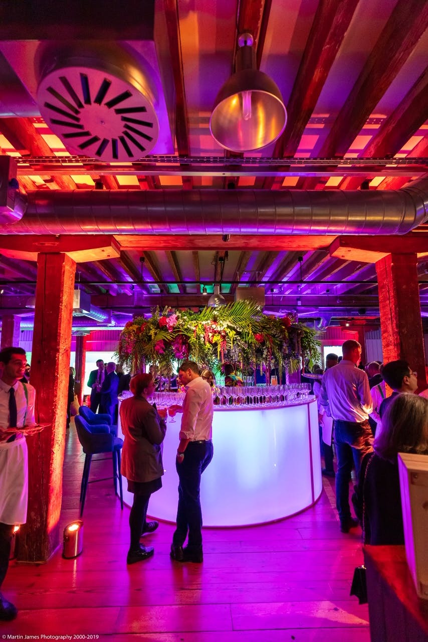 "Vibrant Rum Store bar with floral decor, perfect for networking events in London."