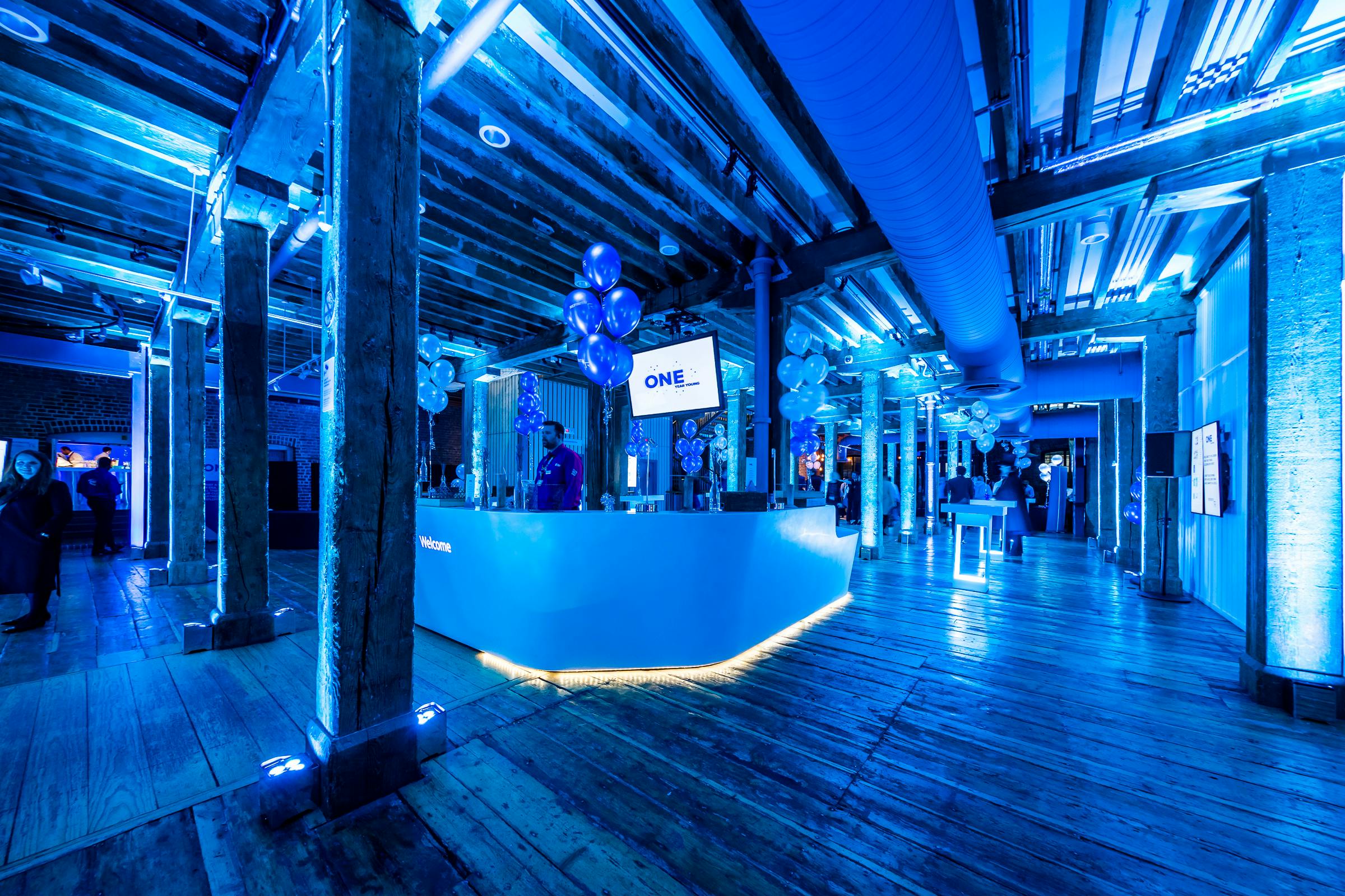 Muscovado Hall at London Museum Docklands, modern event space with blue lighting.