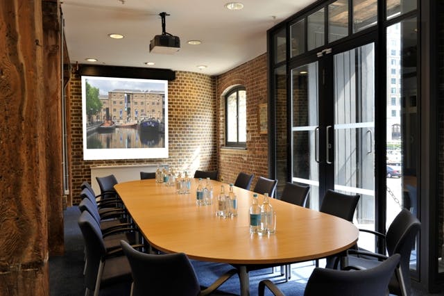 Docklands Boardroom at London Museum, featuring a long wooden table for meetings and events.