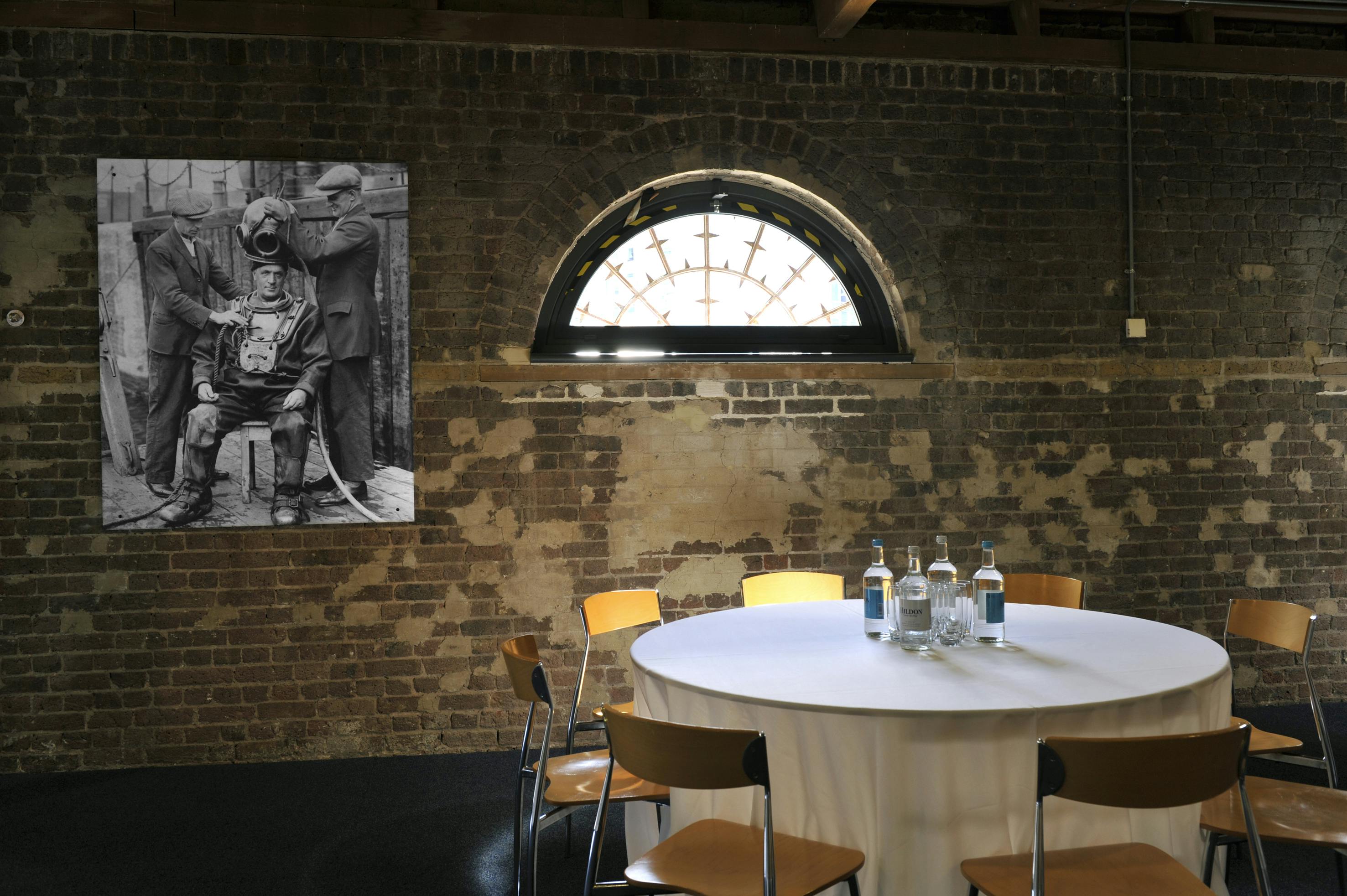 Quayside Room at London Museum Docklands, round table for meetings, creative event space.