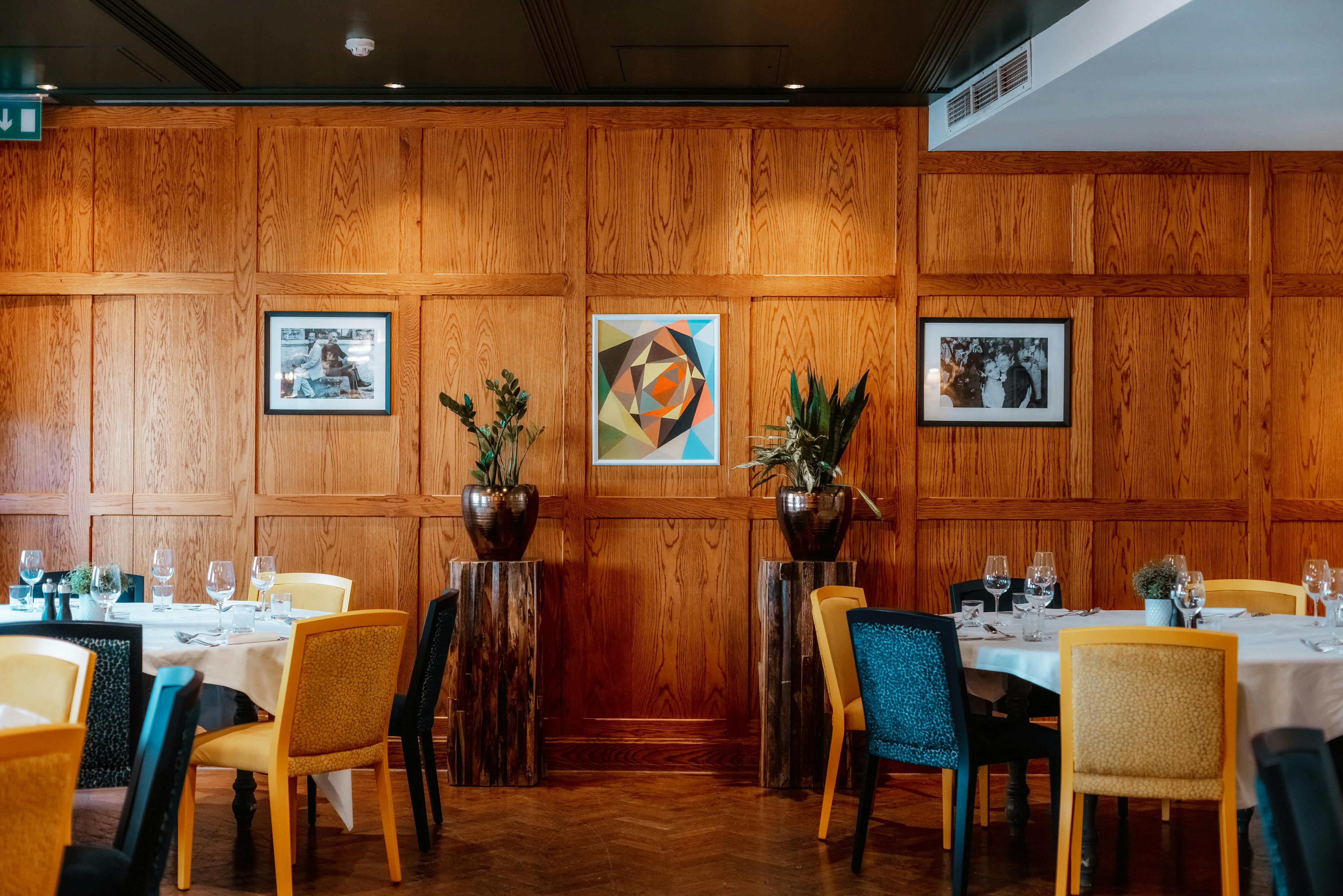 Sophisticated dining room with wooden paneling for corporate events and intimate gatherings.