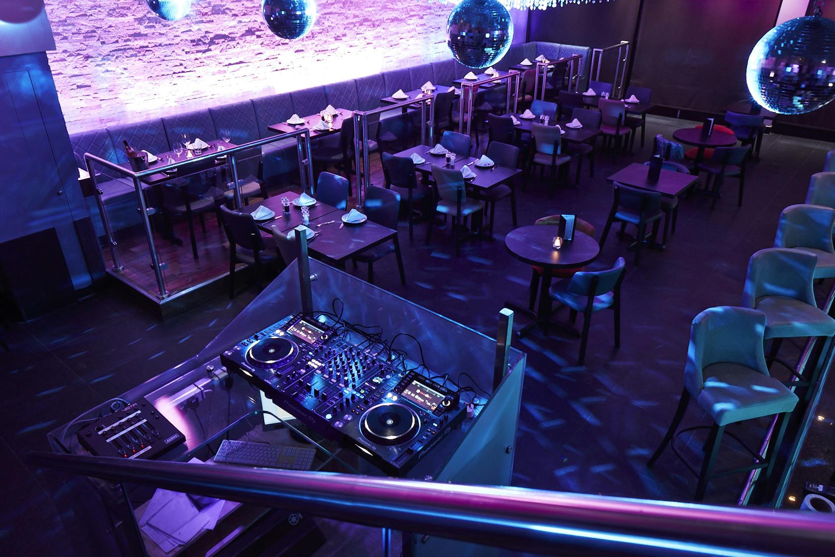 Stylish event space with DJ setup, ideal for corporate events and social gatherings.