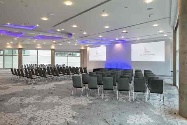 The Lowry Hotel Grand Ballroom: Modern theater-style conference room with professional AV setup.