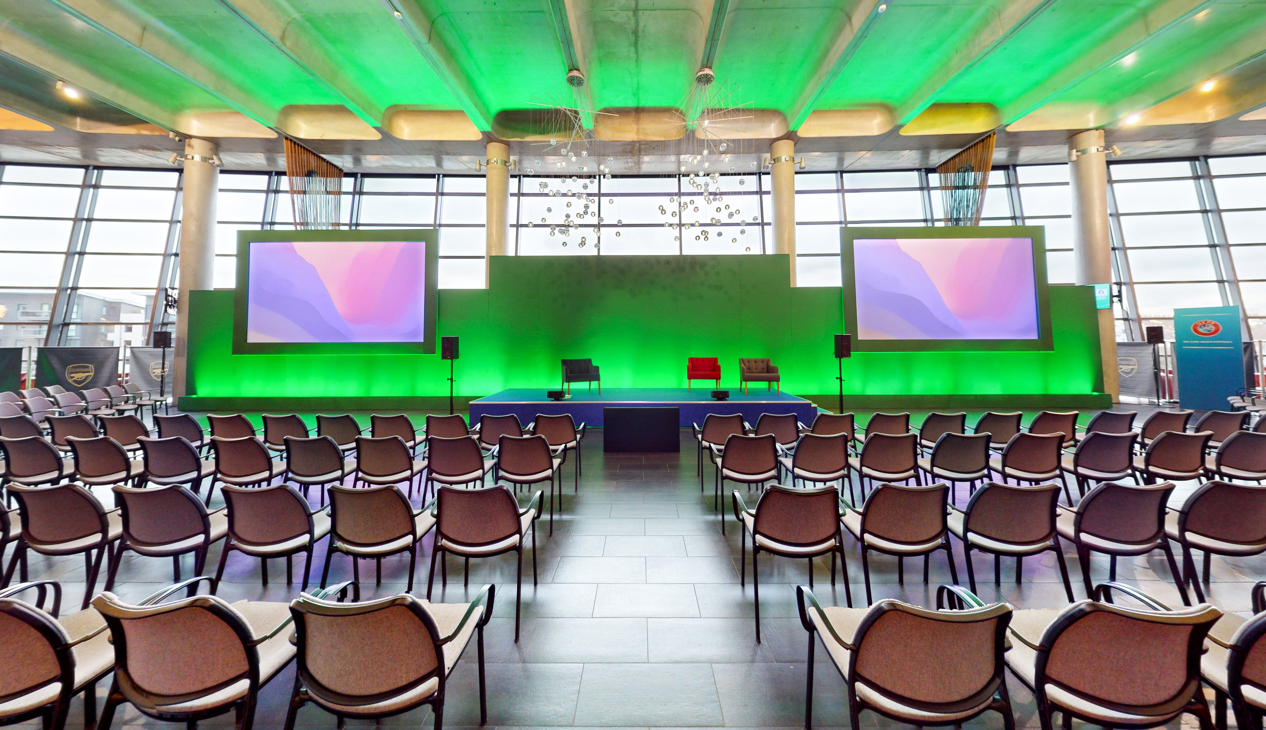 Emirates Stadium event space with modern stage, ideal for conferences and panel discussions. - Banner